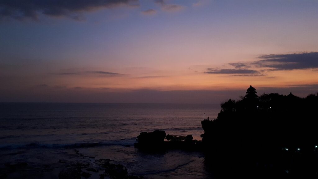 Silhouette of Tanah Lot Temple on a rock at sunset in Bali